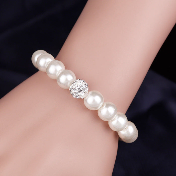 Pearl bracelet on wrist with round beads and a crystal center accent bead