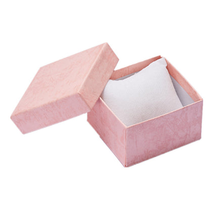 Pink jewelry box with a white interior on a white background