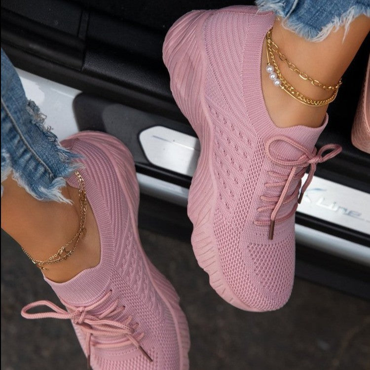 Pink thick-sole dad sneakers with lace-up front and breathable knit upper