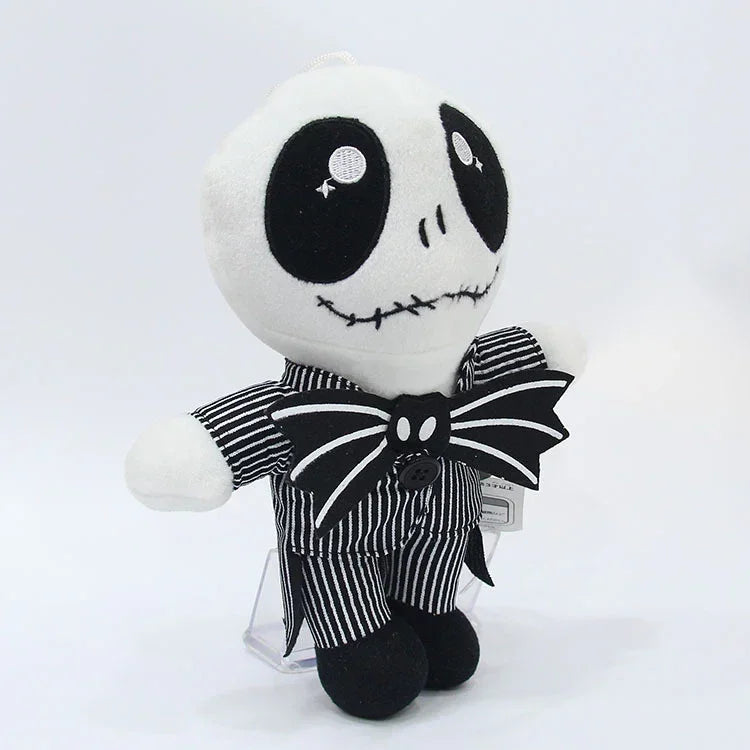 Plush stuffed doll with white head, black button eyes, striped shirt, large bow.