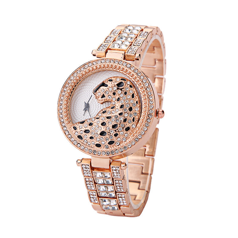 Rose gold watch with crystal embellishments on a white background