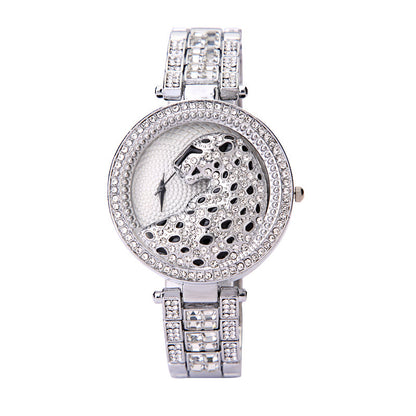 Silver wristwatch with intricate design on a white background