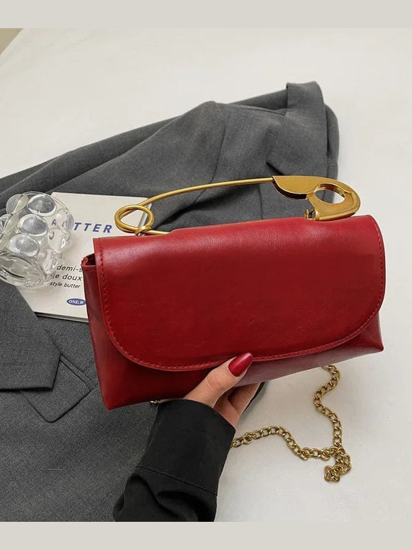 Red PU leather shoulder bag with curved clasp flap and gold chain shoulder strap