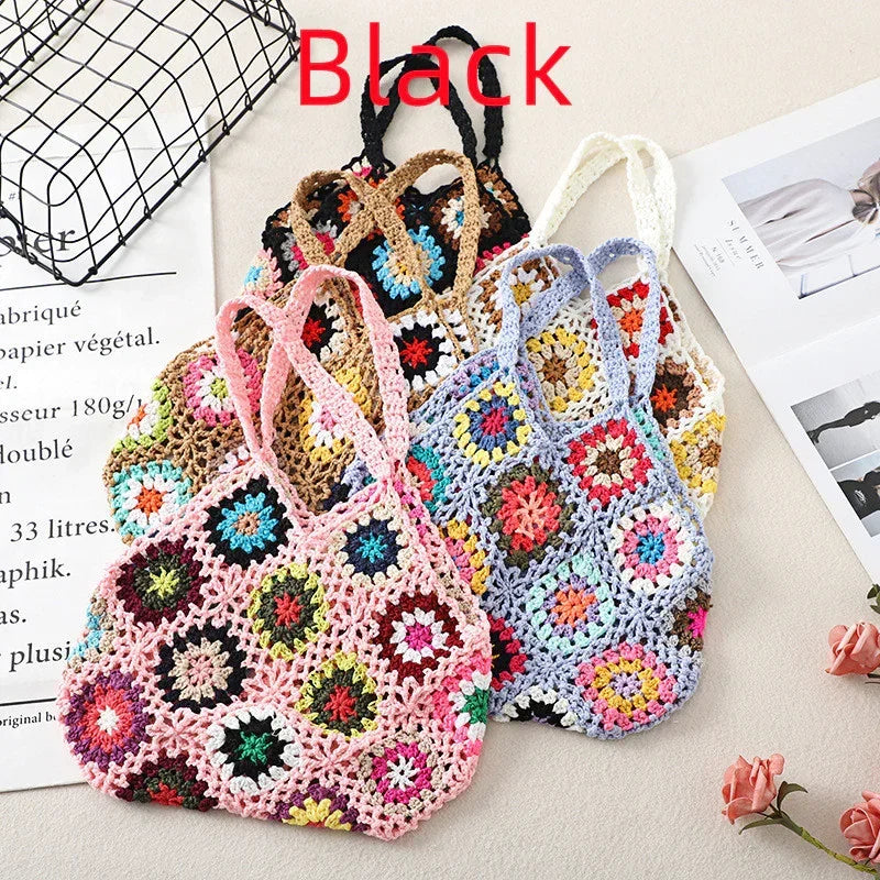 Handmade crochet wool handbag tote with multicolor floral granny squares and black handles.