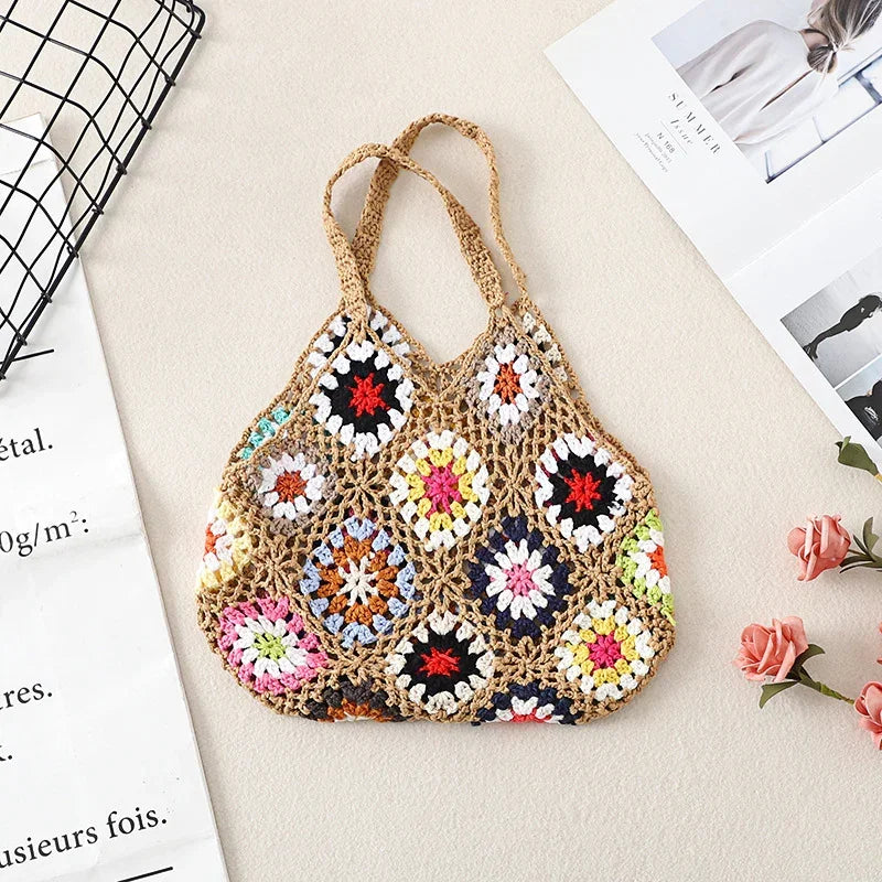 Crochet wool handbag tote with tan mesh base, multicolor floral granny squares, and loop handles.