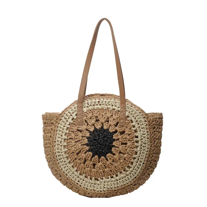 Crochet straw tote bag with dark brown round floral center and brown leather handles