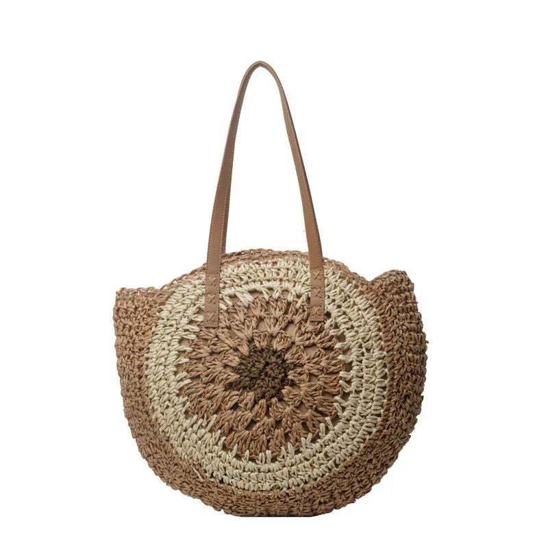 Crochet straw tote bag with dark brown round floral center and brown leather handles