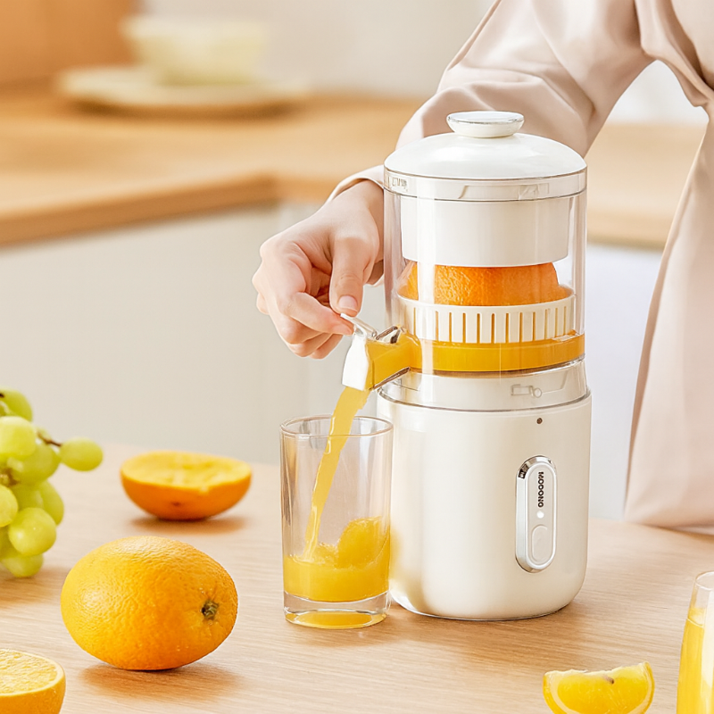 Person using a manual juicer to extract juice from oranges on a kitchen counter.