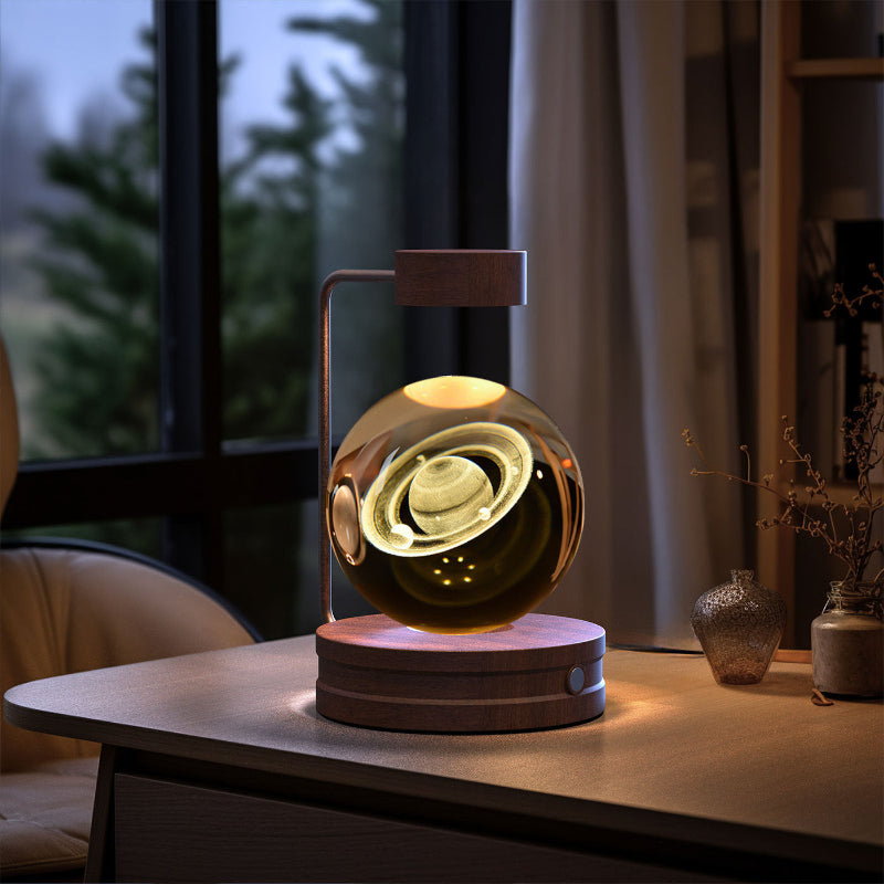 Glowing crystal-ball LED night light on round dark wood base with warm internal swirl.