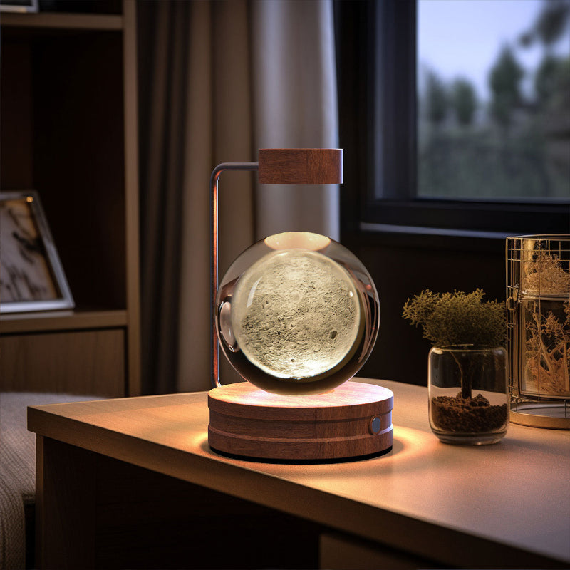 Crystal ball LED night light with glowing globe and wood base, tabletop decor around it