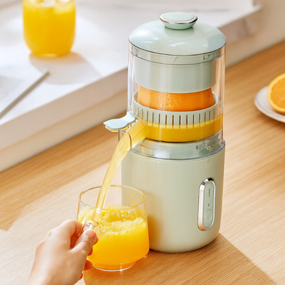 Hand using a manual juicer to extract juice into a glass on a wooden table.