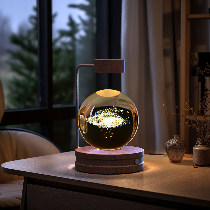 Crystal ball LED night light with sparkling star streaks in clear globe, light wood base