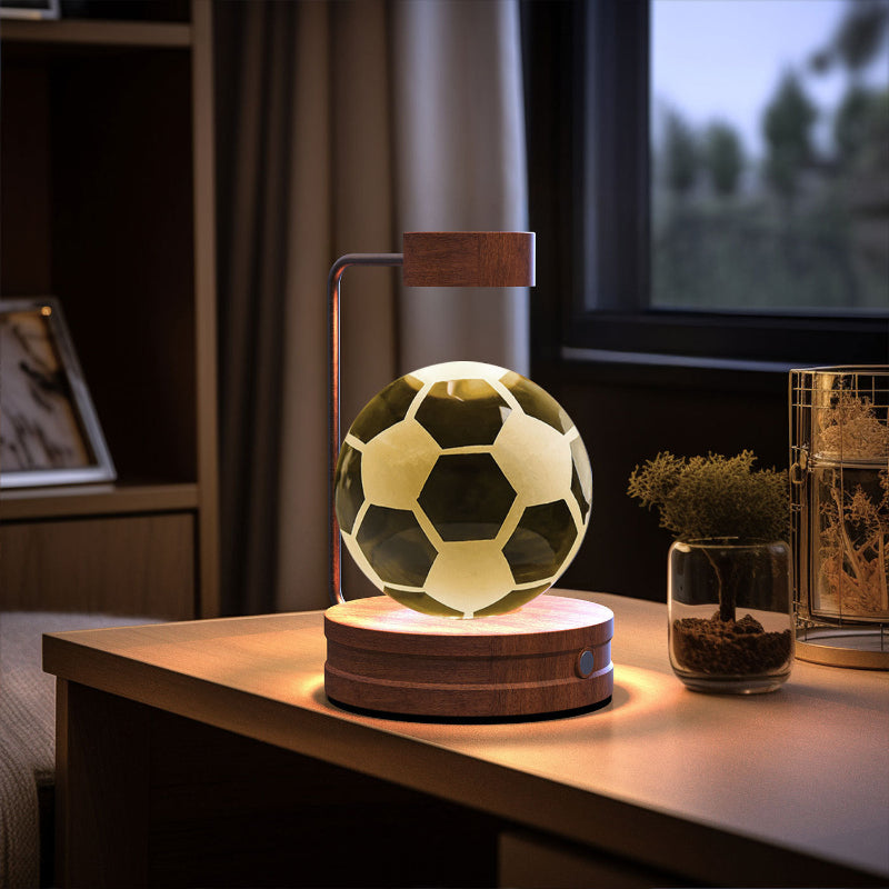Crystal ball LED night light with soccer ball graphic inside clear glowing globe on wood base