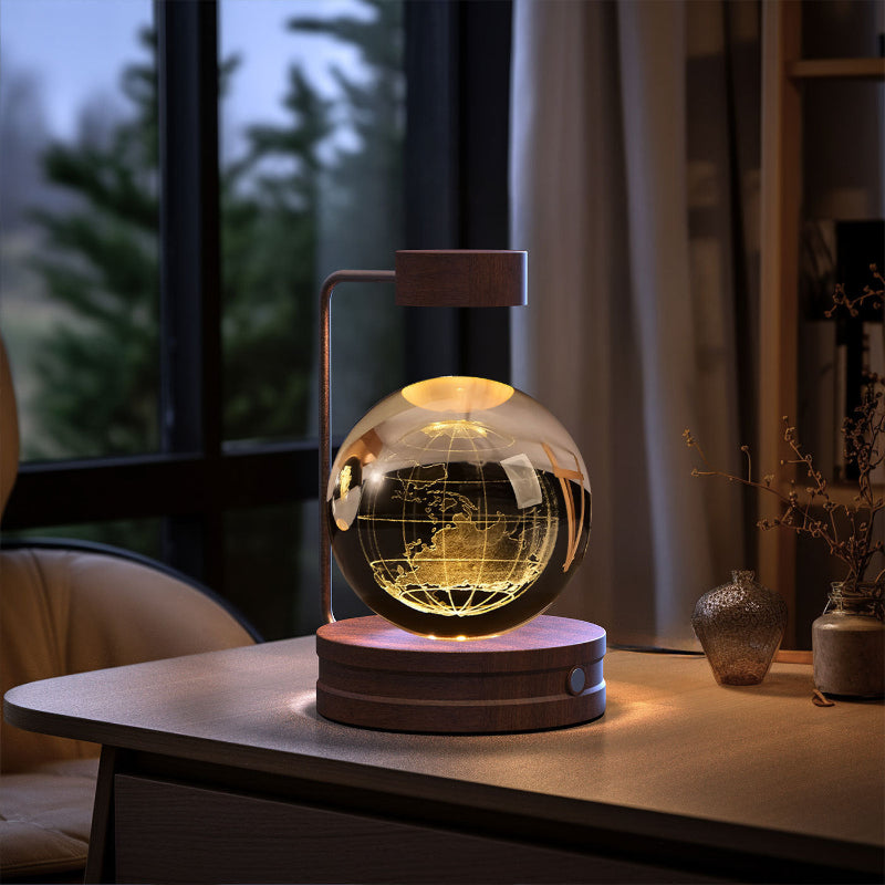 Crystal ball LED night light with starry tree silhouette inside clear globe on wood base