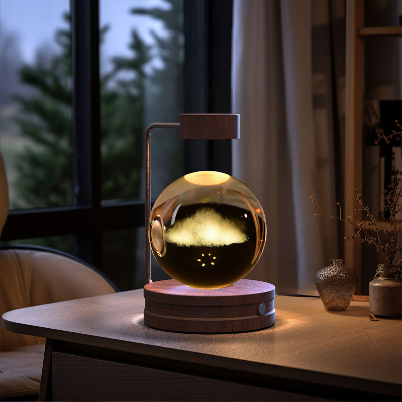 Crystal ball cosmic LED night light with glowing gold horizon pattern in dark glass sphere