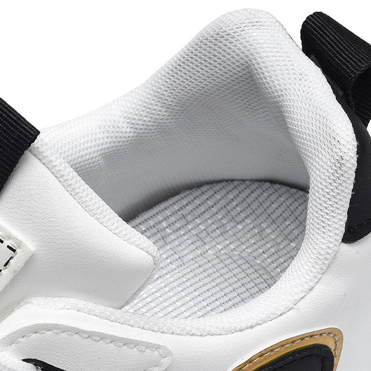 White sneaker inner collar with textured lining and gray insole, black heel tab