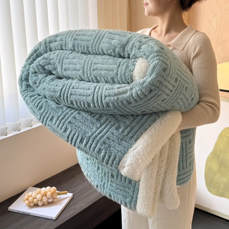 Teal blue plush velvet blanket with textured lines and soft white sherpa border, folded