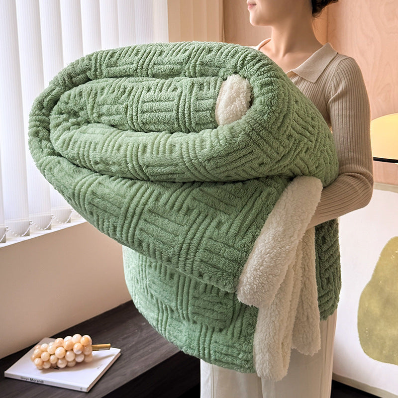 Plush velvet winter blanket in vivid green with textured quilting, striped edge, and plush backing
