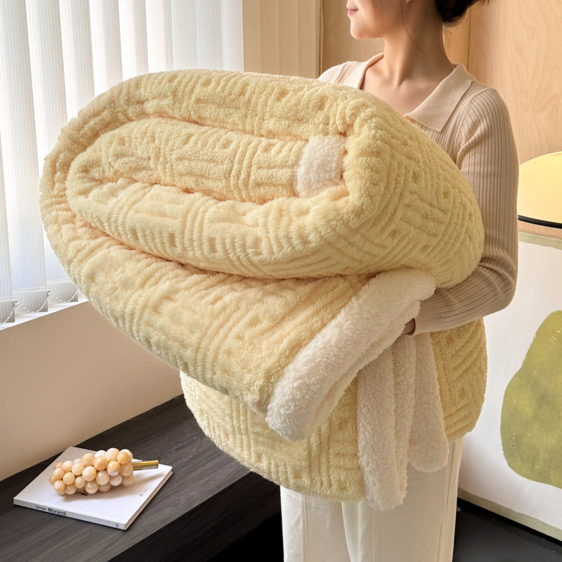 Pale yellow plush velvet blanket with textured stripes and soft white sherpa border, rolled
