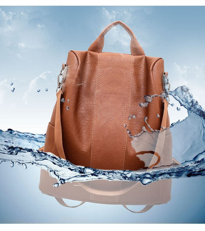Brown leather backpack with water splashes on a blue background