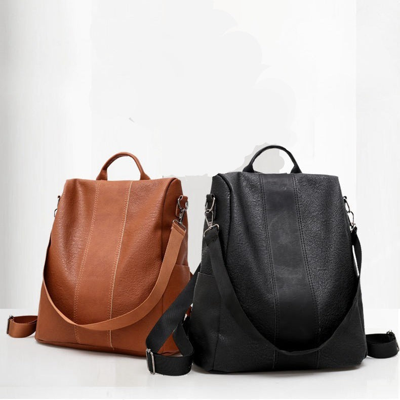 Brown and black leather backpacks on a white background