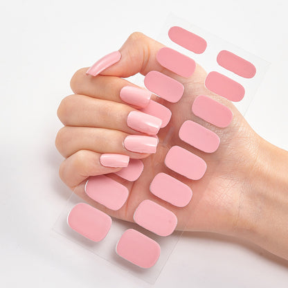 Hand holding pink nail pads with additional pads displayed on a white background