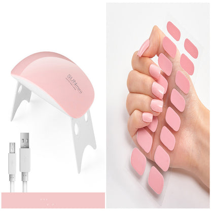 Pink nail care device with USB cable and nail stickers on a white background