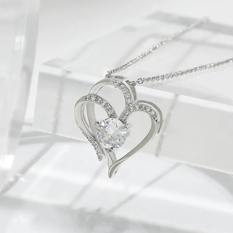 Silver-tone double heart pendant necklace with sparkling pave hearts and center round stone