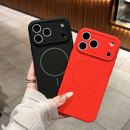 Black and red phone cases held by a hand on a neutral background
