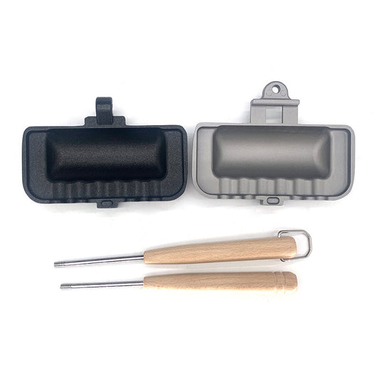 Two grill pans and two wooden-handled tools on a white background