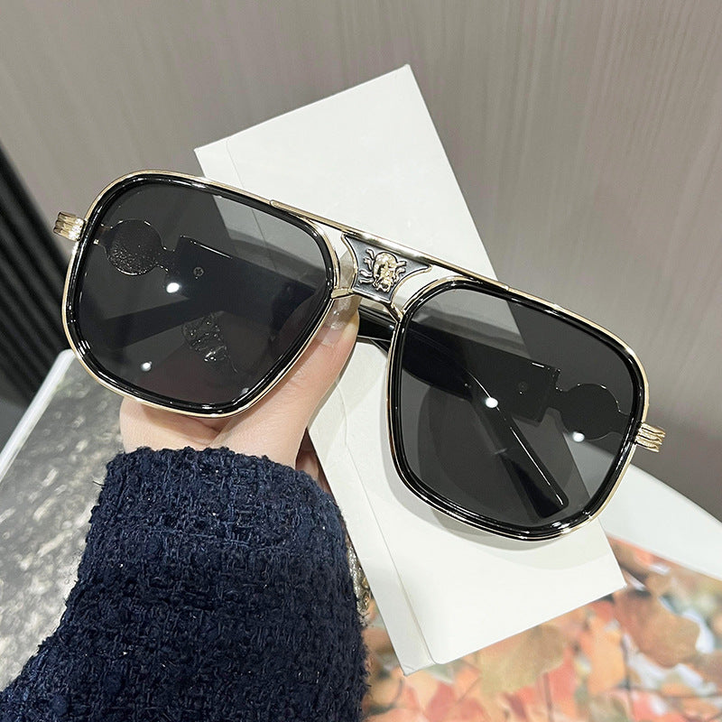 Classic unisex sunglasses with black lenses and gold-tone frame, rounded square shape