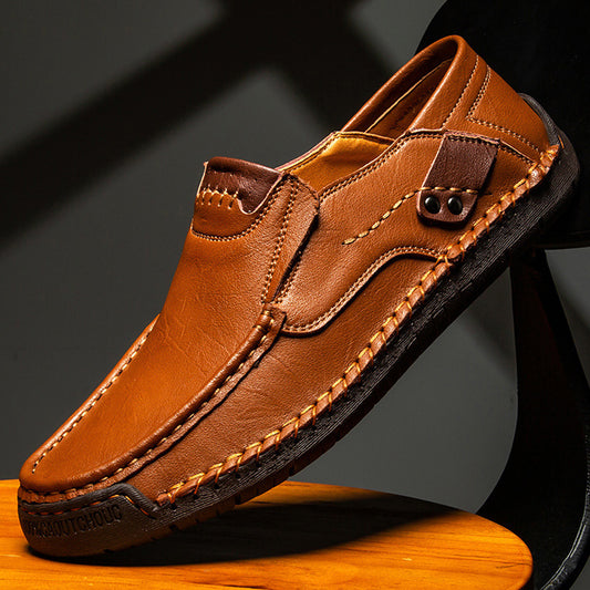 Brown leather shoe on a wooden block with a dark background