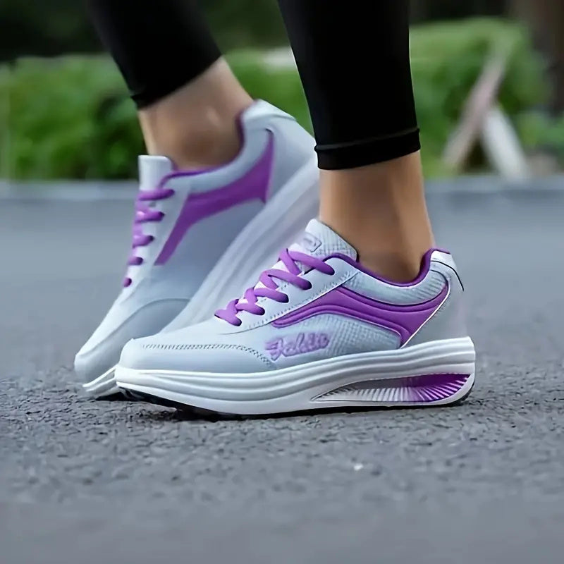 Women’s purple-laced lace-up sneakers with white sole worn with black leggings
