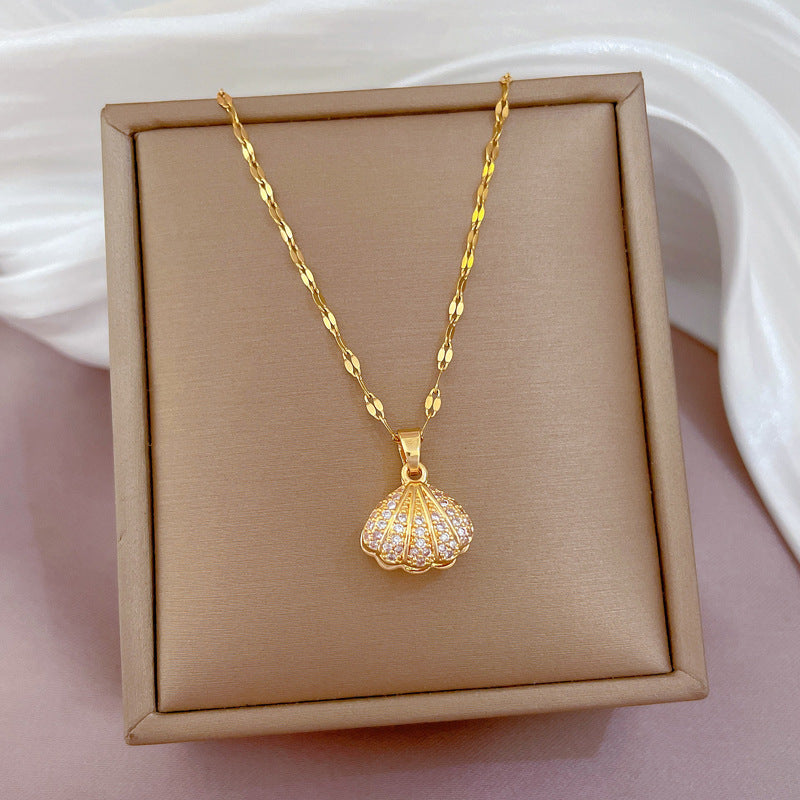 Gold tone seashell pendant necklace in gift box, featuring round pearl and rhinestones
