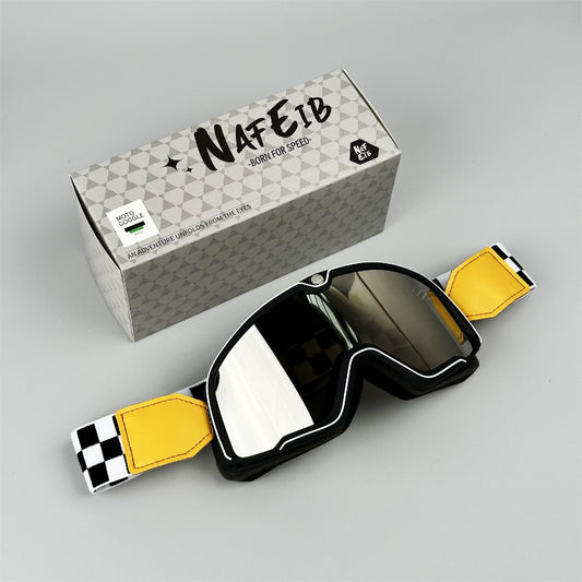 Motorcycle goggles with yellow straps and a branded box on a gray background