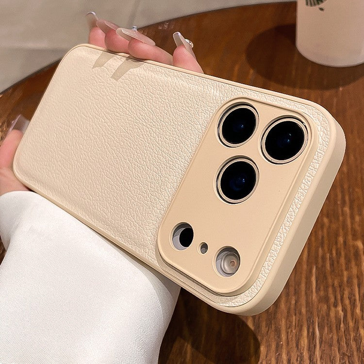 Beige phone case held by a person on a wooden surface