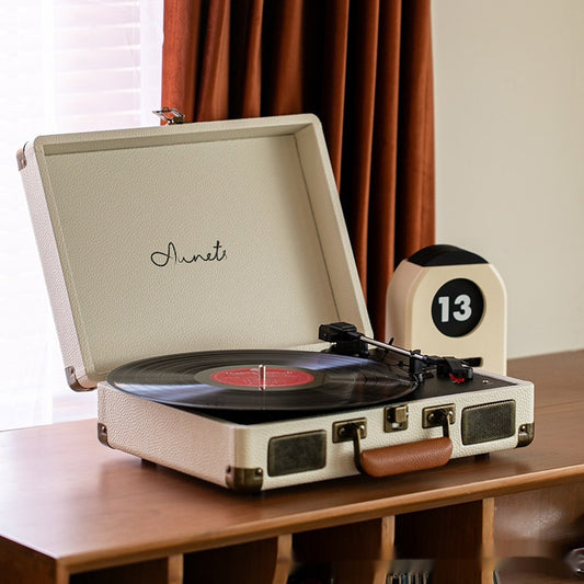 Cream portable Bluetooth record player phonograph with turntable and control knobs