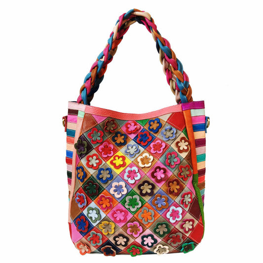 Colorful handbag with floral patterns and braided handle on a white background