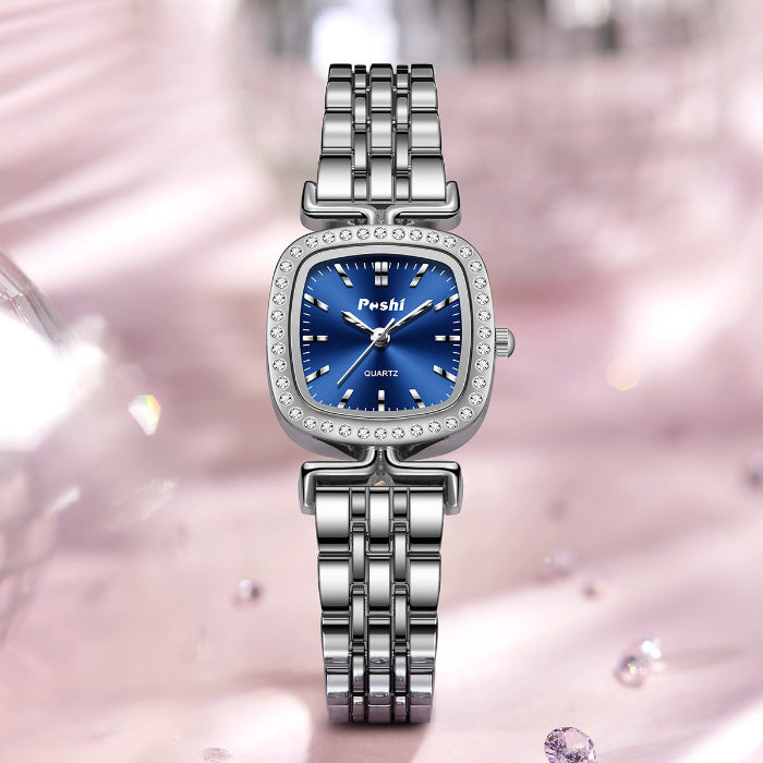 Women’s quartz watch with diamond-encrusted bezel, blue dial, and silver metal bracelet