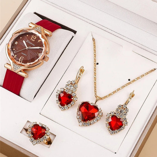 Jewelry set with a watch, necklace, and earrings featuring red gemstones on a white background.