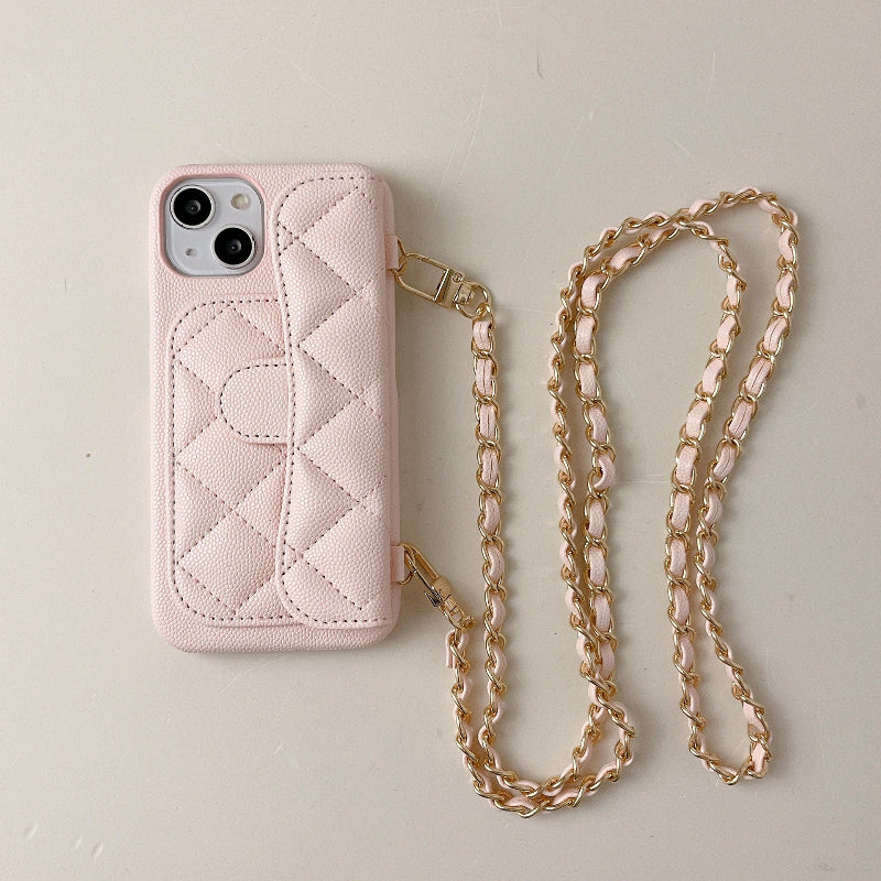 Pink quilted phone case with a chain strap on a light gray background