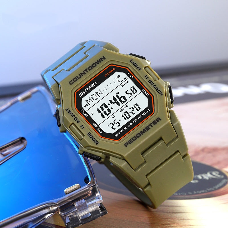 Army-green SKMEI digital sports watch shown at an angle on a clear stand