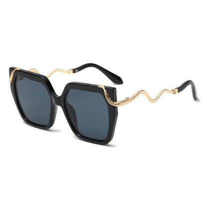 Black sunglasses with gold chain details on a white background