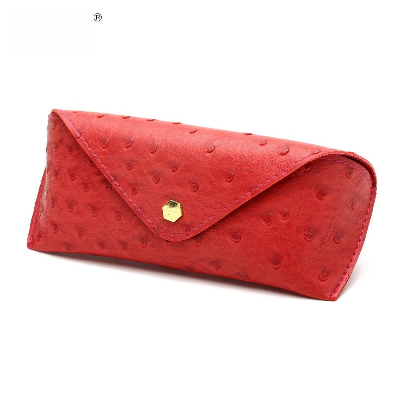 Red polka dot leather sunglasses case with curved flap and gold-tone clasp