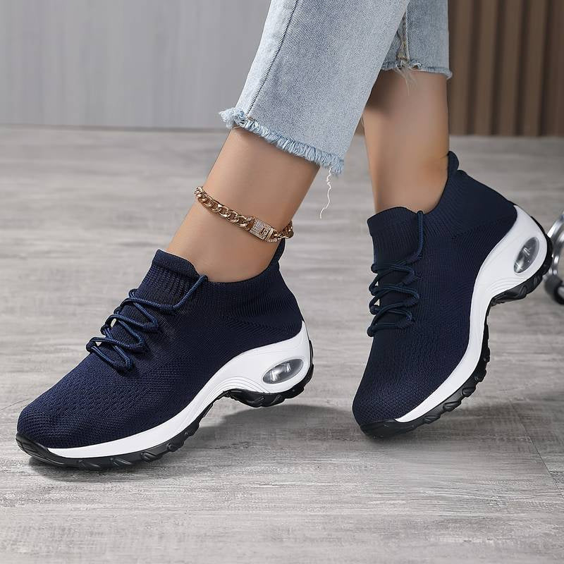 Navy knit lace-up athletic shoes with white sole and oval air window detail