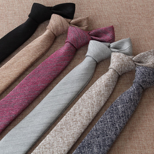 Set of various ties in different colors on a textured surface