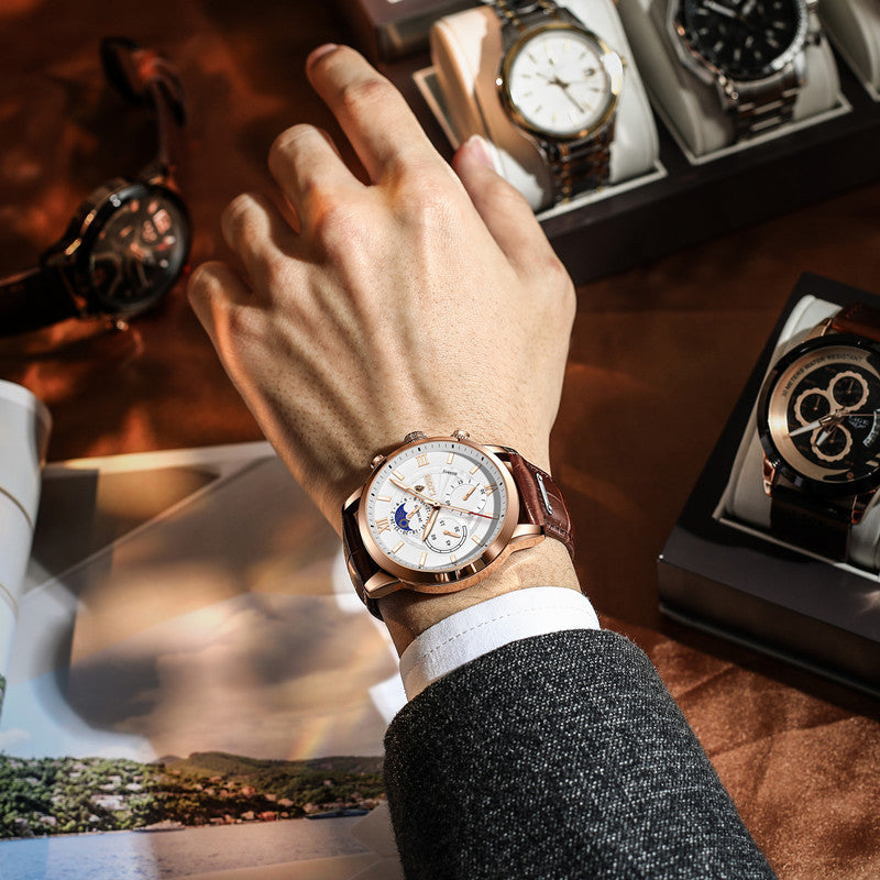 Rose gold chronograph quartz watch on wrist with brown leather strap
