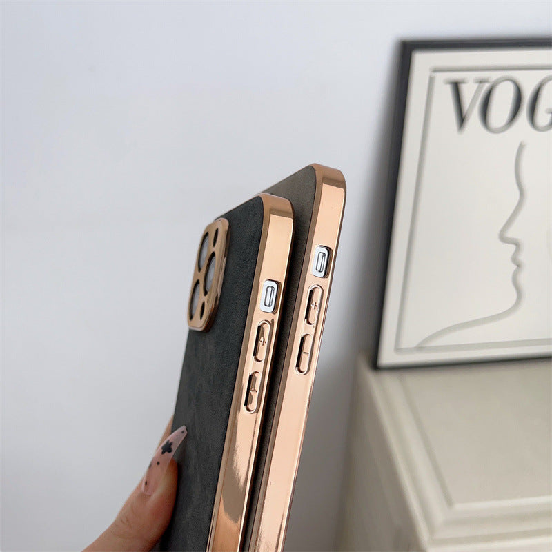 Phone case with rose gold edge held by a hand, Vogue magazine in the background