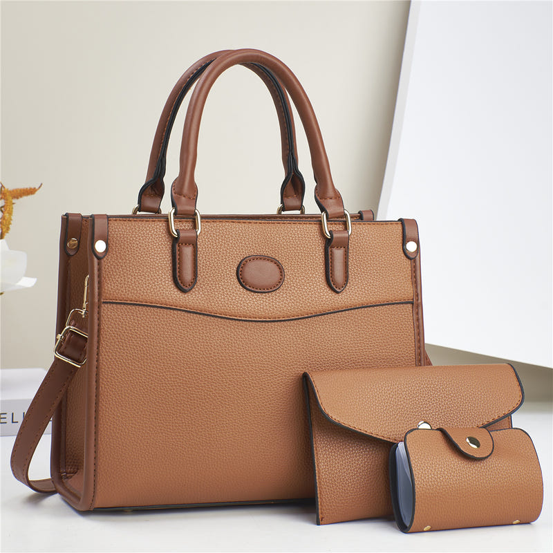Three-piece shoulder bag set in warm brown with tan trim: structured tote plus two pouches
