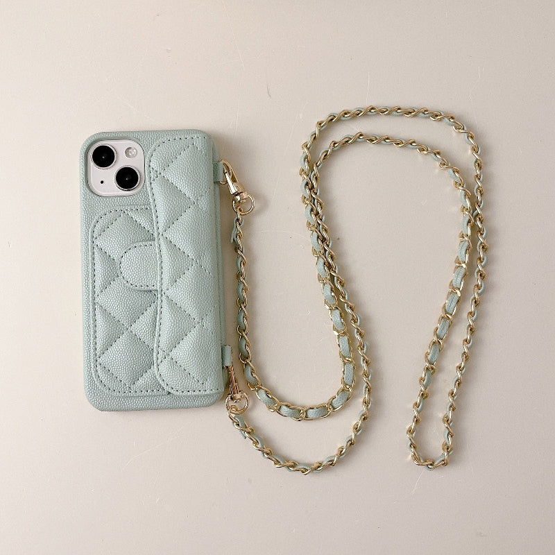 Light blue quilted phone case with a gold chain on a beige background